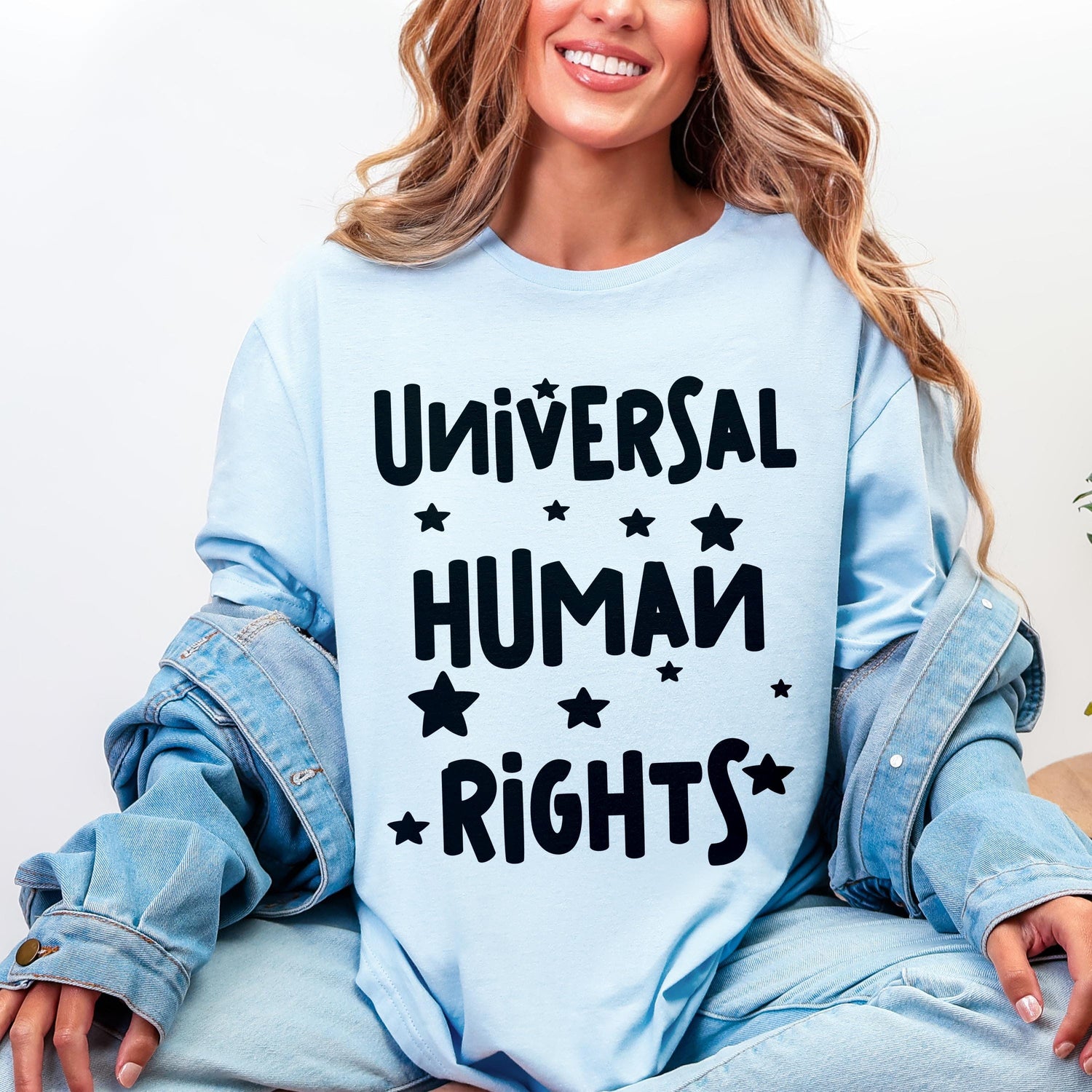 Light blue long-sleeve shirt with &amp;quot;Universal Human Rights&amp;quot; text and stars.