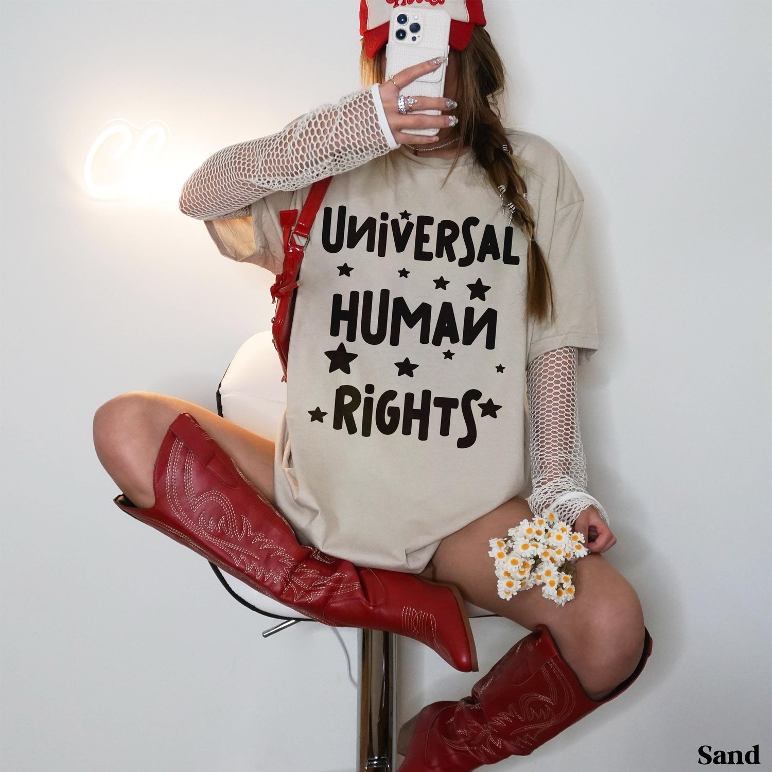T-shirt with &amp;quot;Universal Human Rights&amp;quot; text, worn by a seated person in red boots.