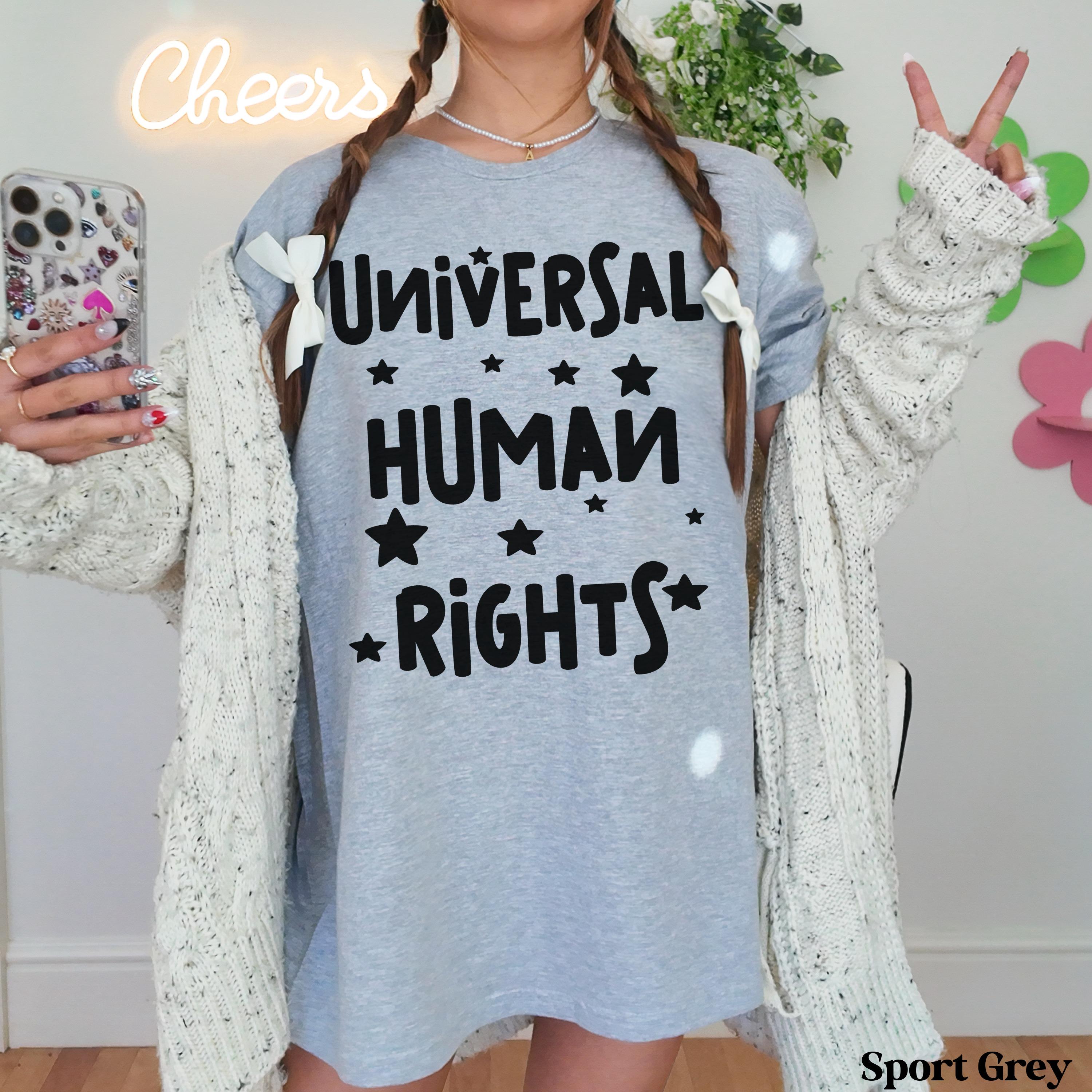 Grey t-shirt with &amp;quot;Universal Human Rights&amp;quot; text and white stars, worn by a person.