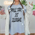Grey t-shirt with "POLL TAX IS ILLEGAL" text, worn by a person.
