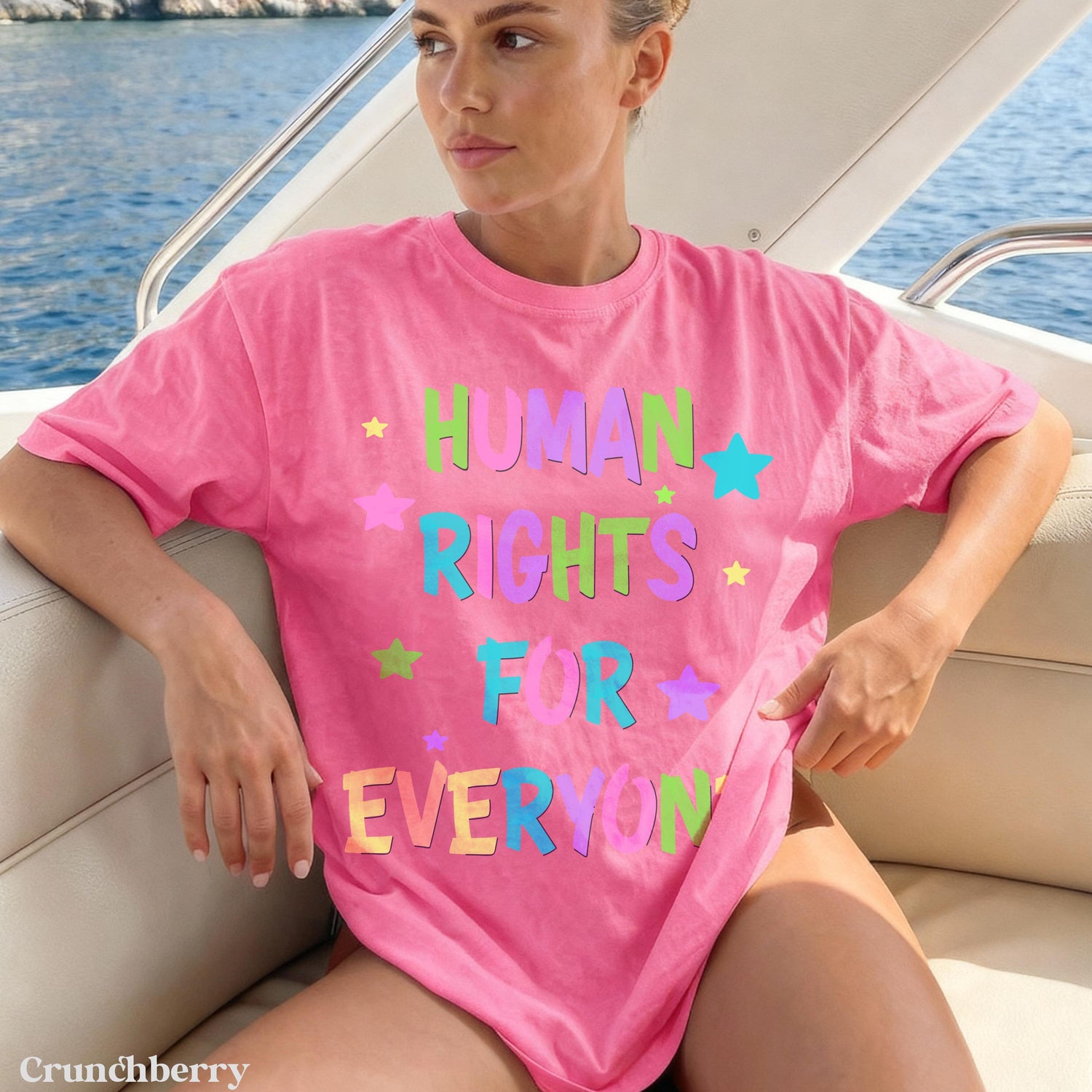 Woman wearing a pink t-shirt with &amp;quot;HUMAN RIGHTS FOR EVERYONE&amp;quot; in colorful lettering.