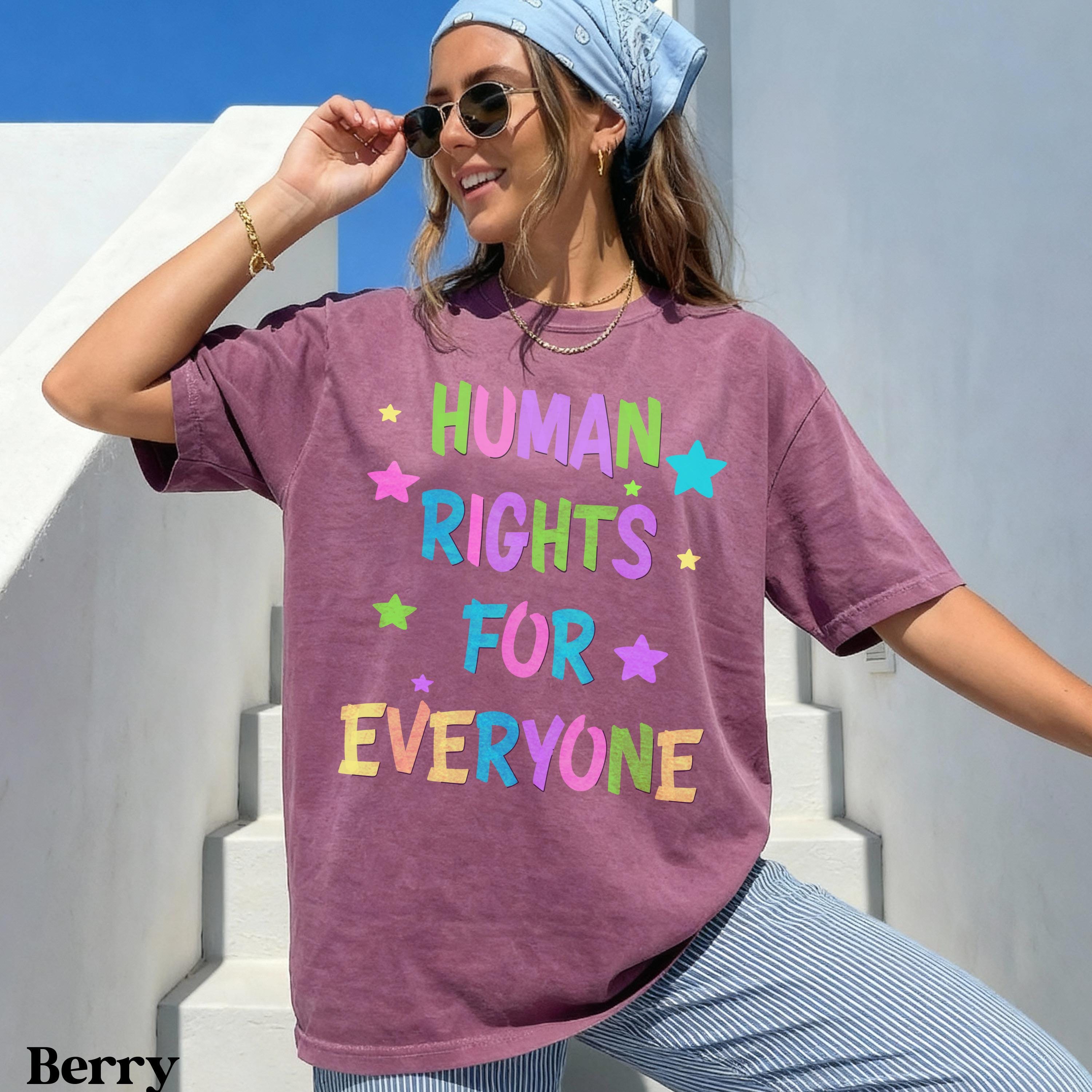 Woman wearing berry t-shirt with &amp;quot;HUMAN RIGHTS FOR EVERYONE&amp;quot; in colorful letters.