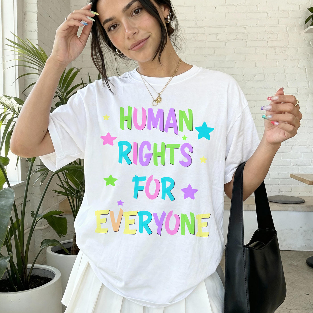 Woman wearing white t-shirt with &amp;quot;Human Rights for Everyone&amp;quot; text.