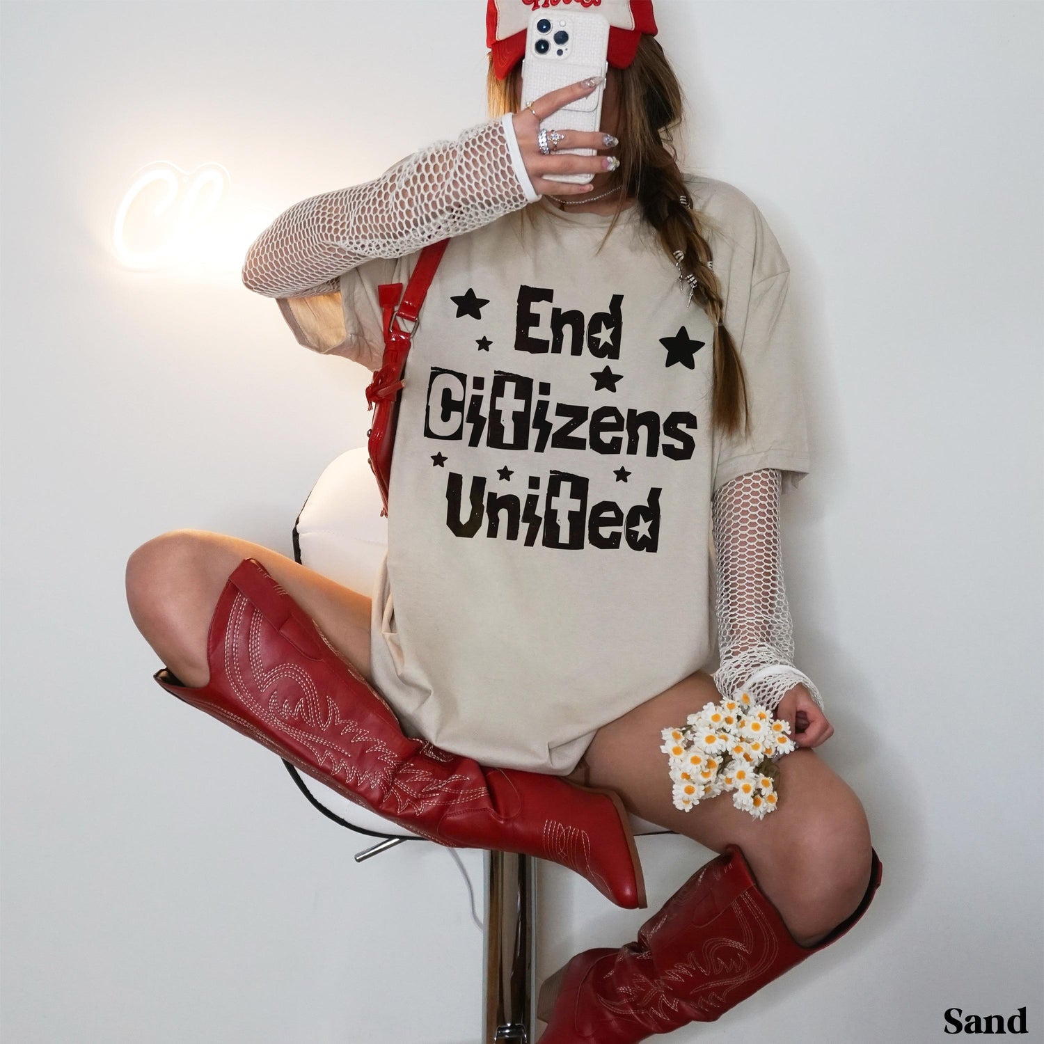 Person wearing a beige t-shirt with &amp;quot;End Citizens United&amp;quot; text and red cowboy boots.