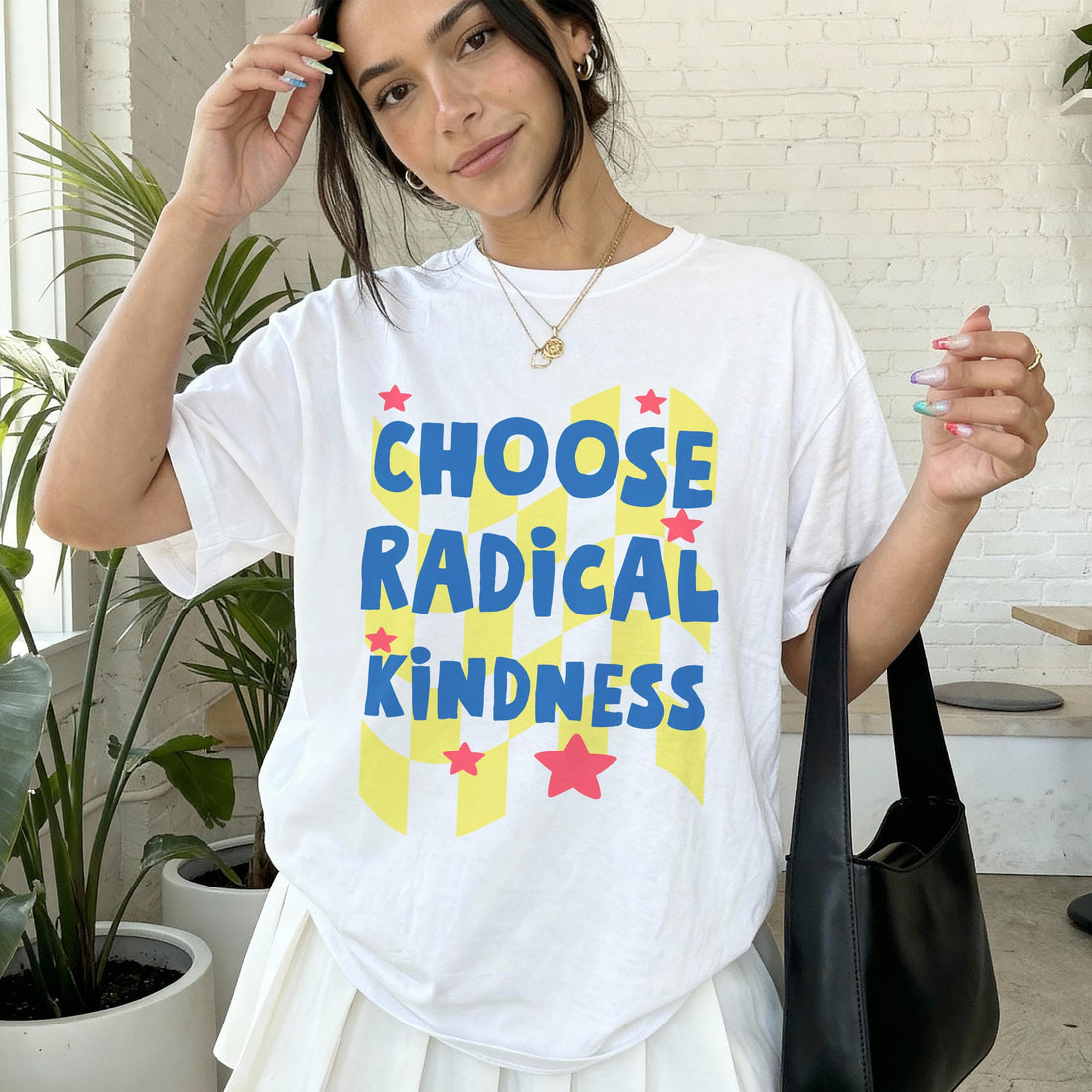 Woman wearing white t-shirt with &amp;quot;CHOOSE RADICAL KINDNESS&amp;quot; text and red stars.