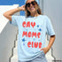 Light blue t-shirt with red and blue "GAY MOMS CLUB" text and stars.