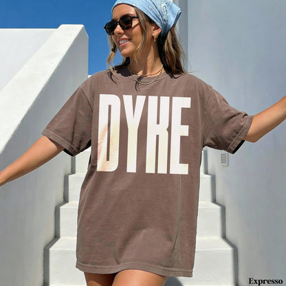 Brown t-shirt with white &amp;quot;DYKE&amp;quot; text, person in sunglasses and bandana.