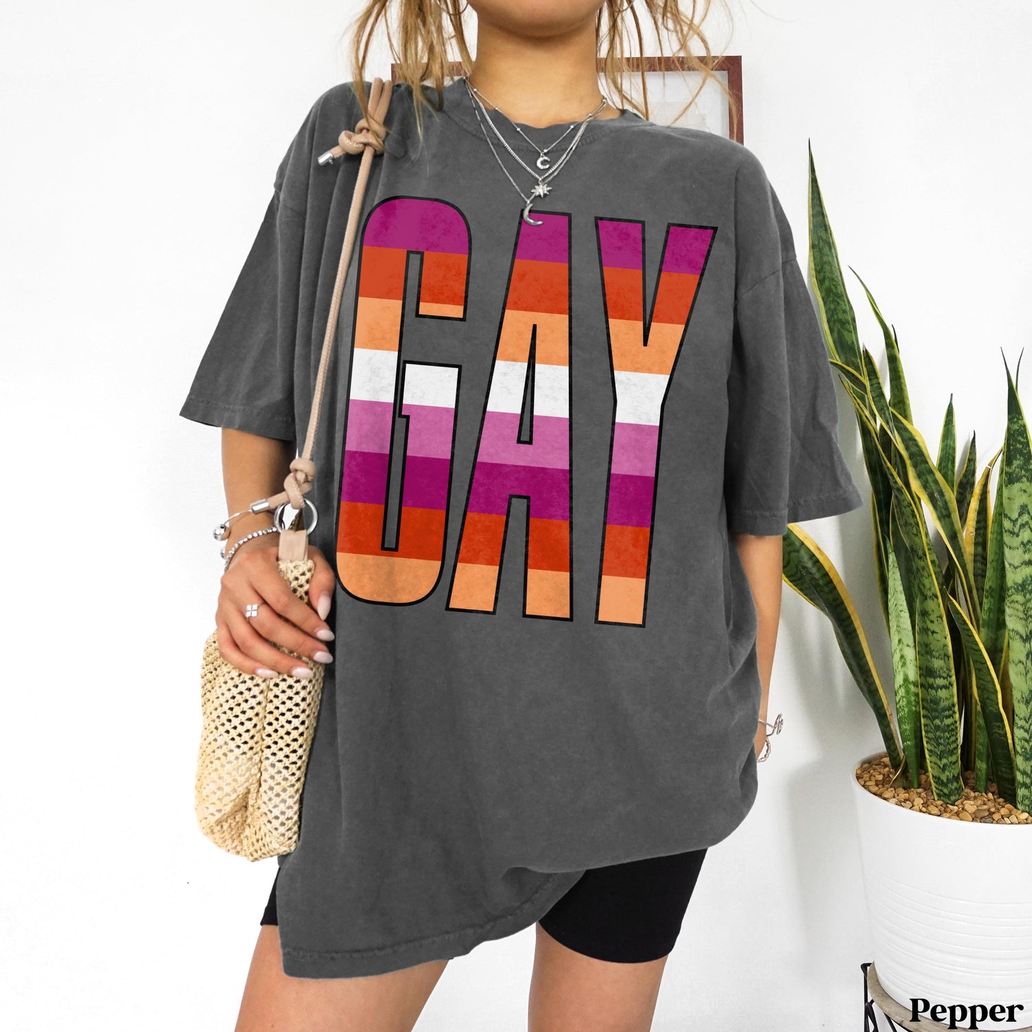 T-shirt with large &amp;quot;GAY&amp;quot; text in pink, orange, and purple stripes.