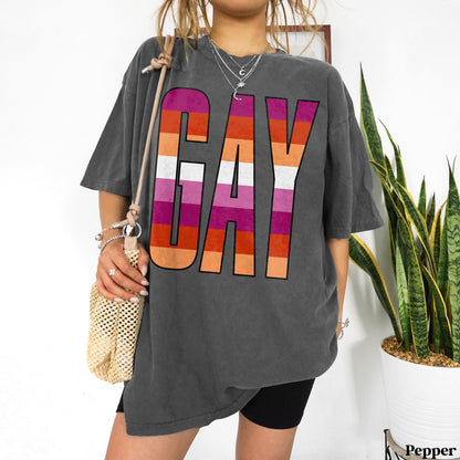 T-shirt with large &amp;quot;GAY&amp;quot; text in pink, orange, and purple stripes.