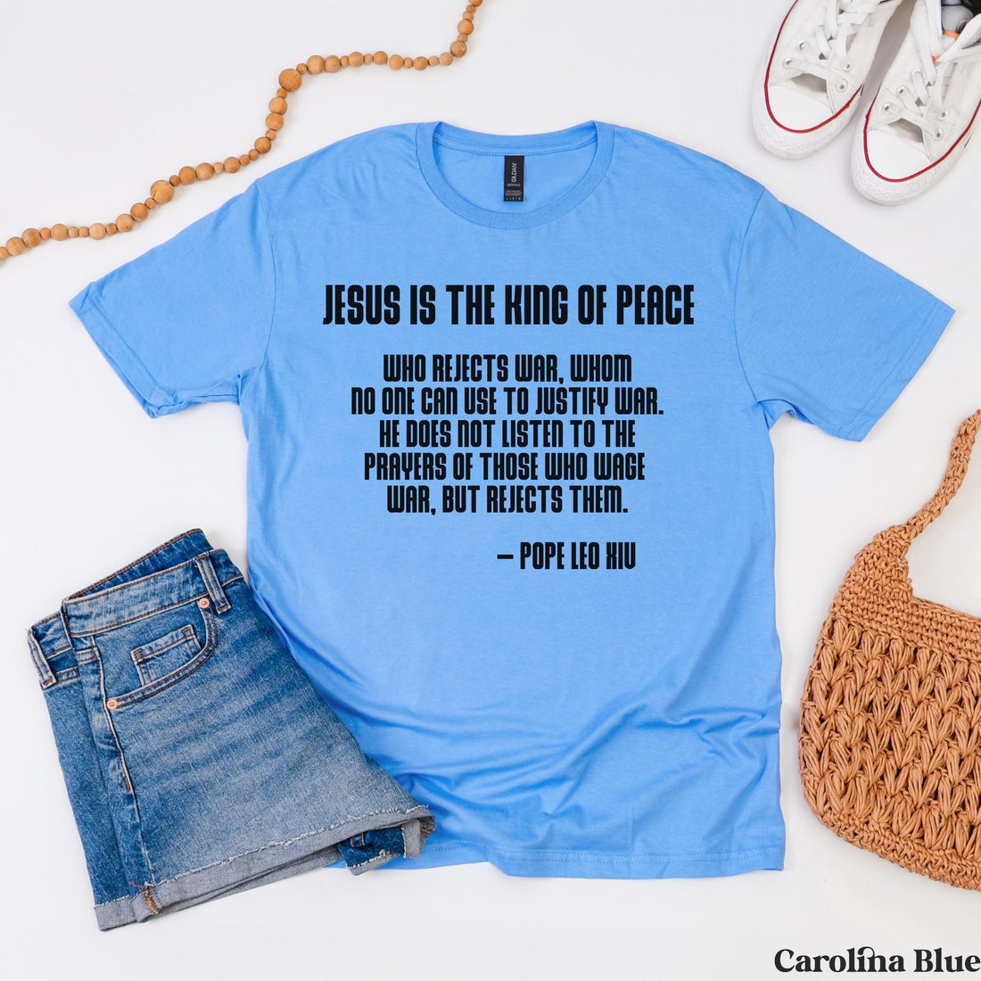 Light blue t-shirt with Pope Leo X quote about Jesus being the King of Peace.