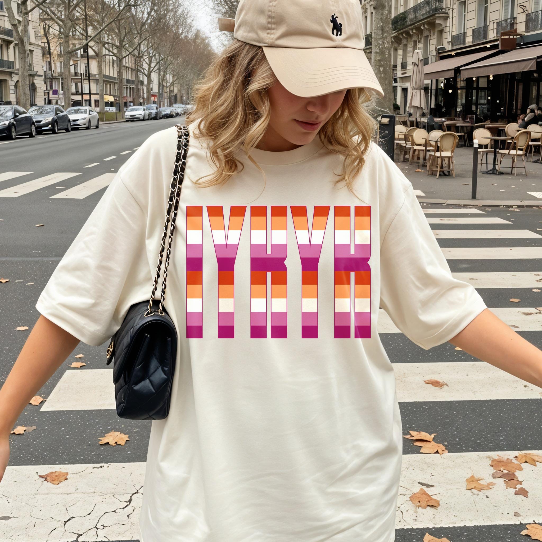 Cream t-shirt with colorful &amp;quot;NYBK&amp;quot; lettering on a pedestrian crossing.