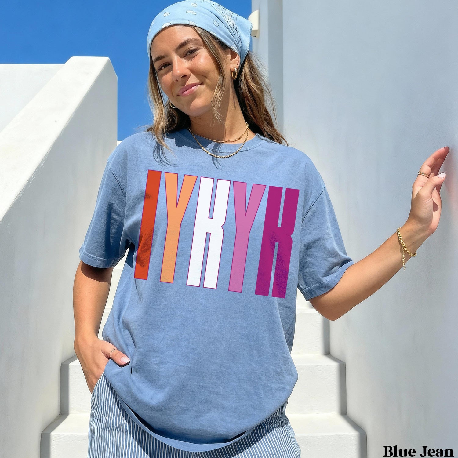 Woman wearing a blue t-shirt with &amp;quot;IYRKH&amp;quot; in pink, white, and orange text.