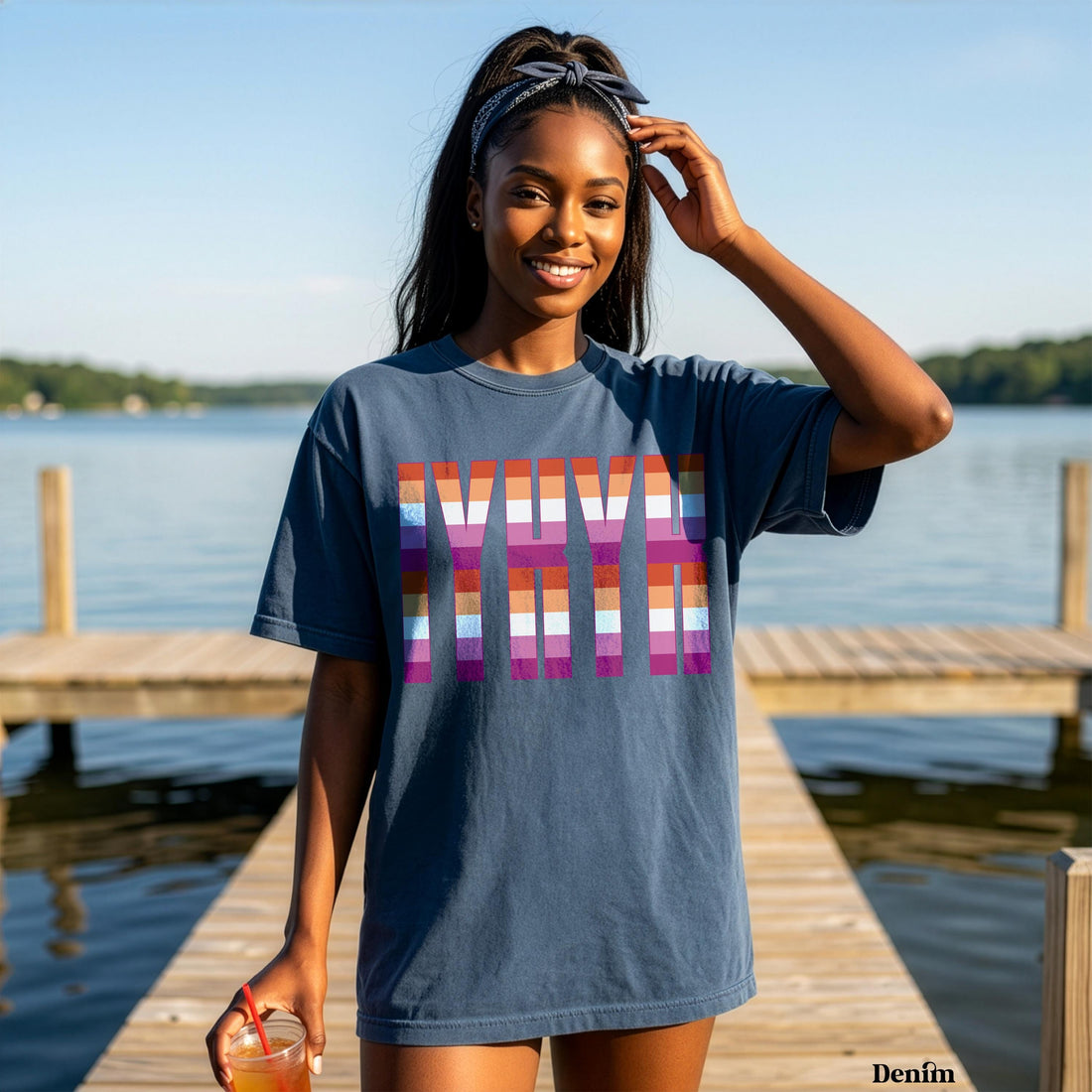 Woman wearing a blue t-shirt with &amp;quot;MAMA&amp;quot; in rainbow stripes.