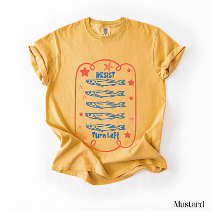 Mustard t-shirt with red text and blue fish graphic.