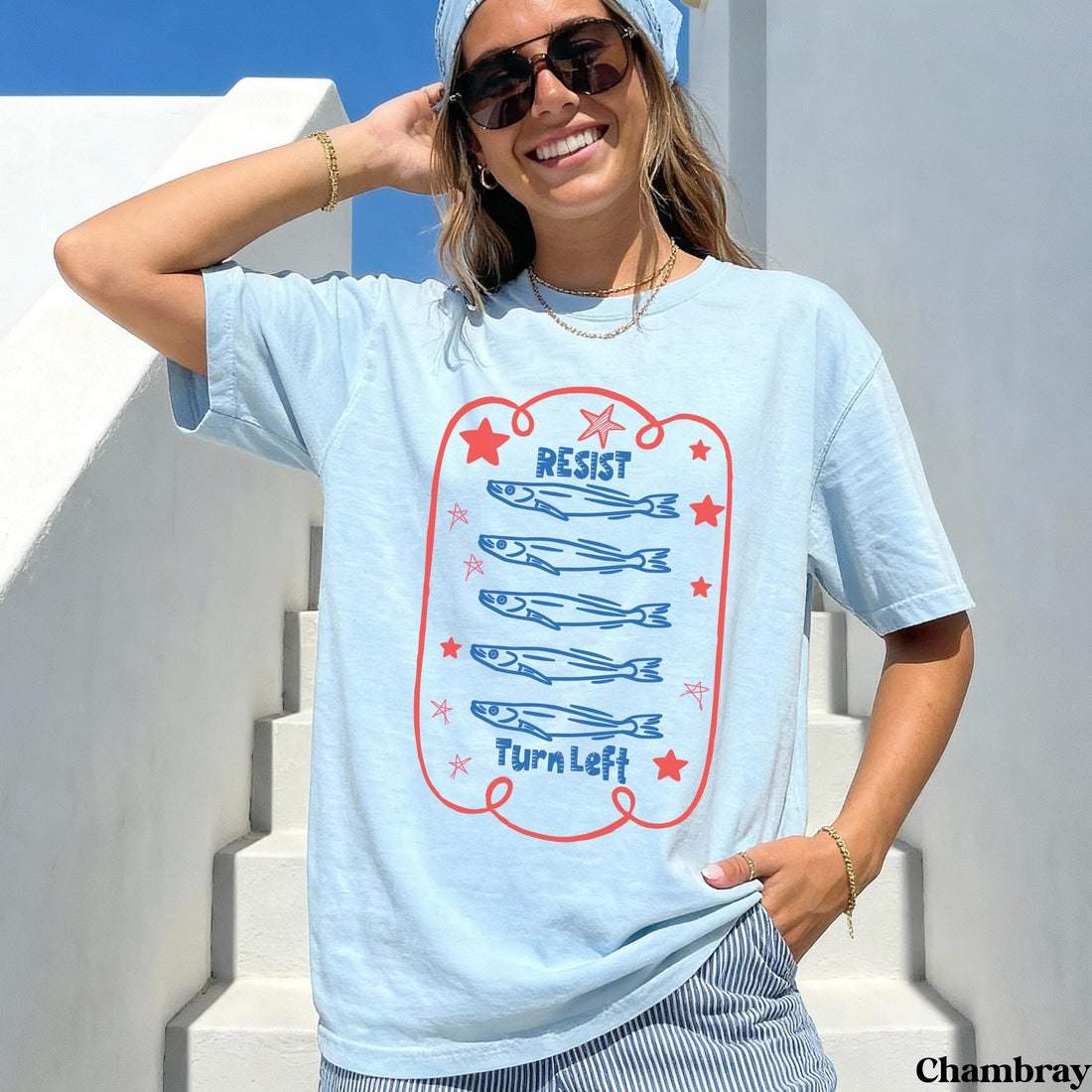 Light blue t-shirt with cartoon fish and &amp;quot;RESIST TURN LEFT&amp;quot; text.