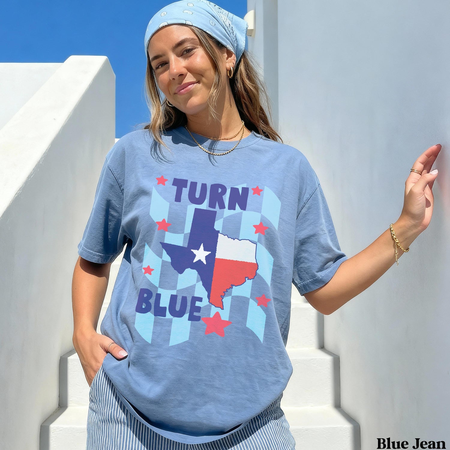 Blue t-shirt with Texas flag and &amp;quot;TURN BLUE&amp;quot; text on checkered background.