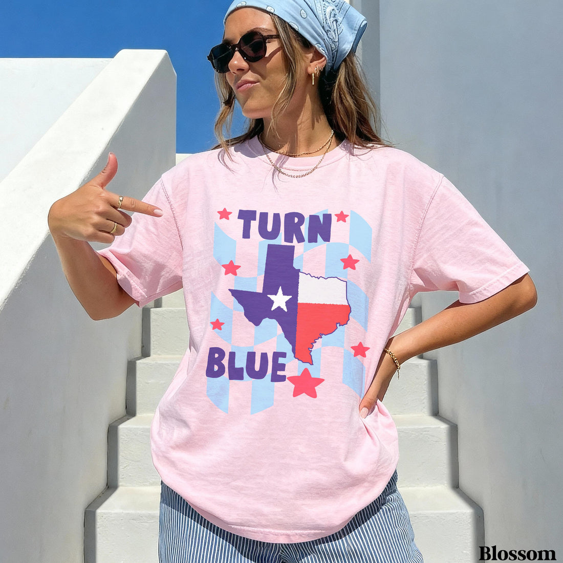 Woman pointing to pink t-shirt with Texas flag and &amp;quot;TURN BLUE&amp;quot; text.
