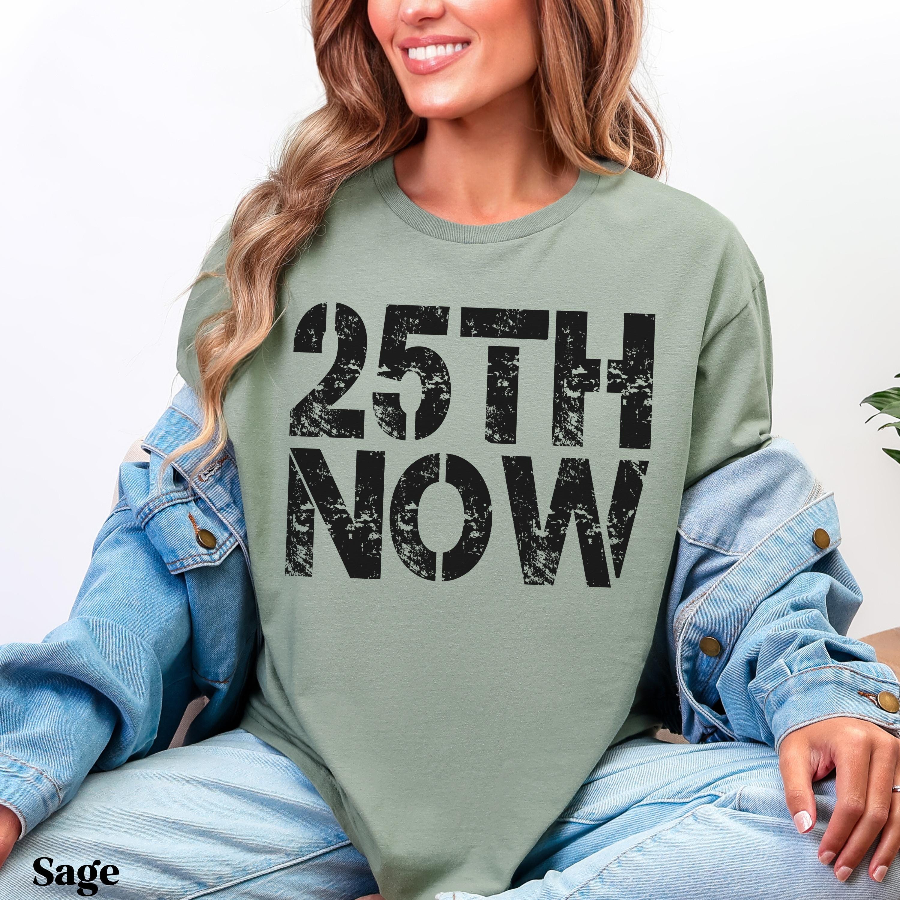 Sage green t-shirt with &amp;quot;25TH NOW&amp;quot; in bold black lettering.