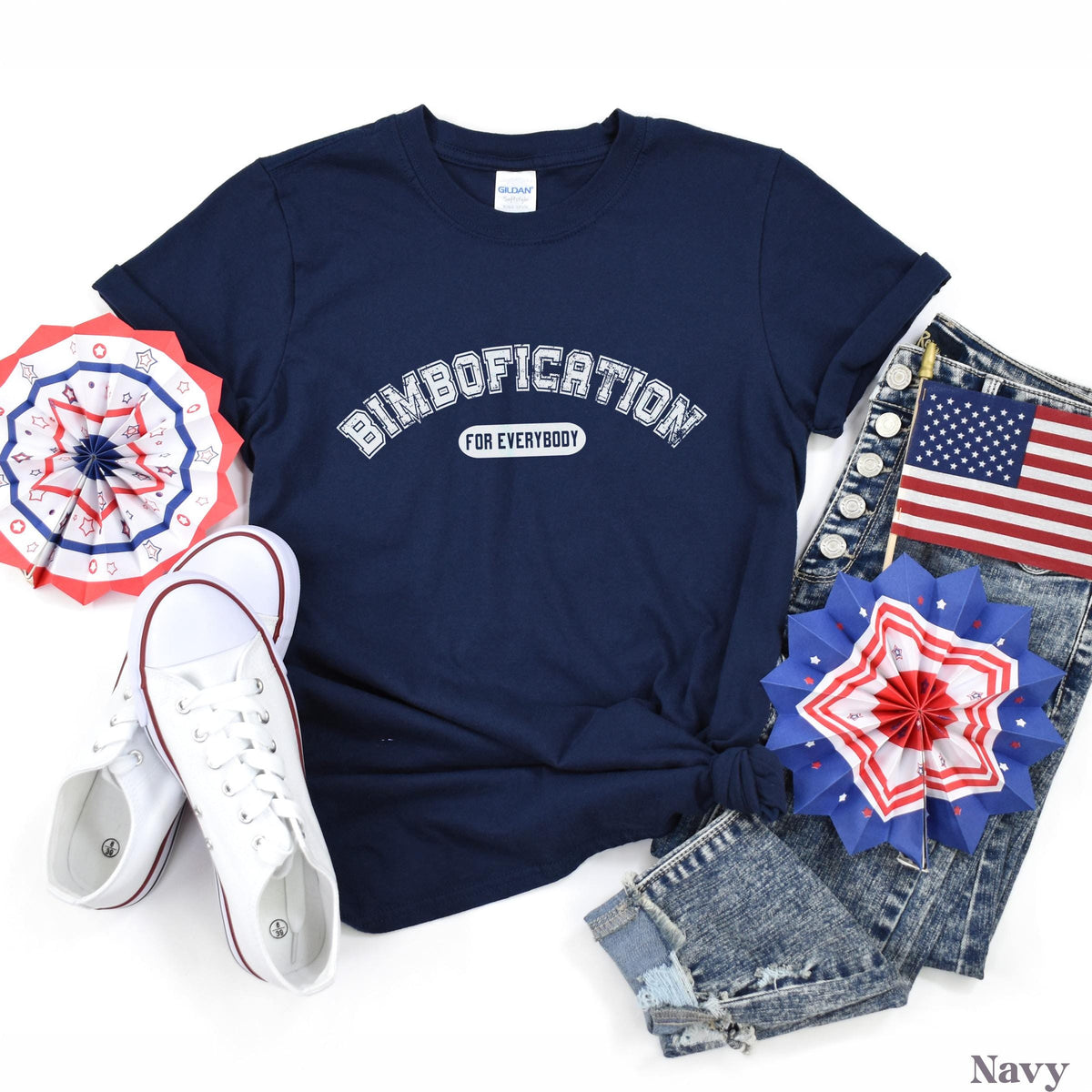 Navy t-shirt with &amp;quot;Bimbofication for Everybody&amp;quot; text, placed with jeans and patriotic decorations.