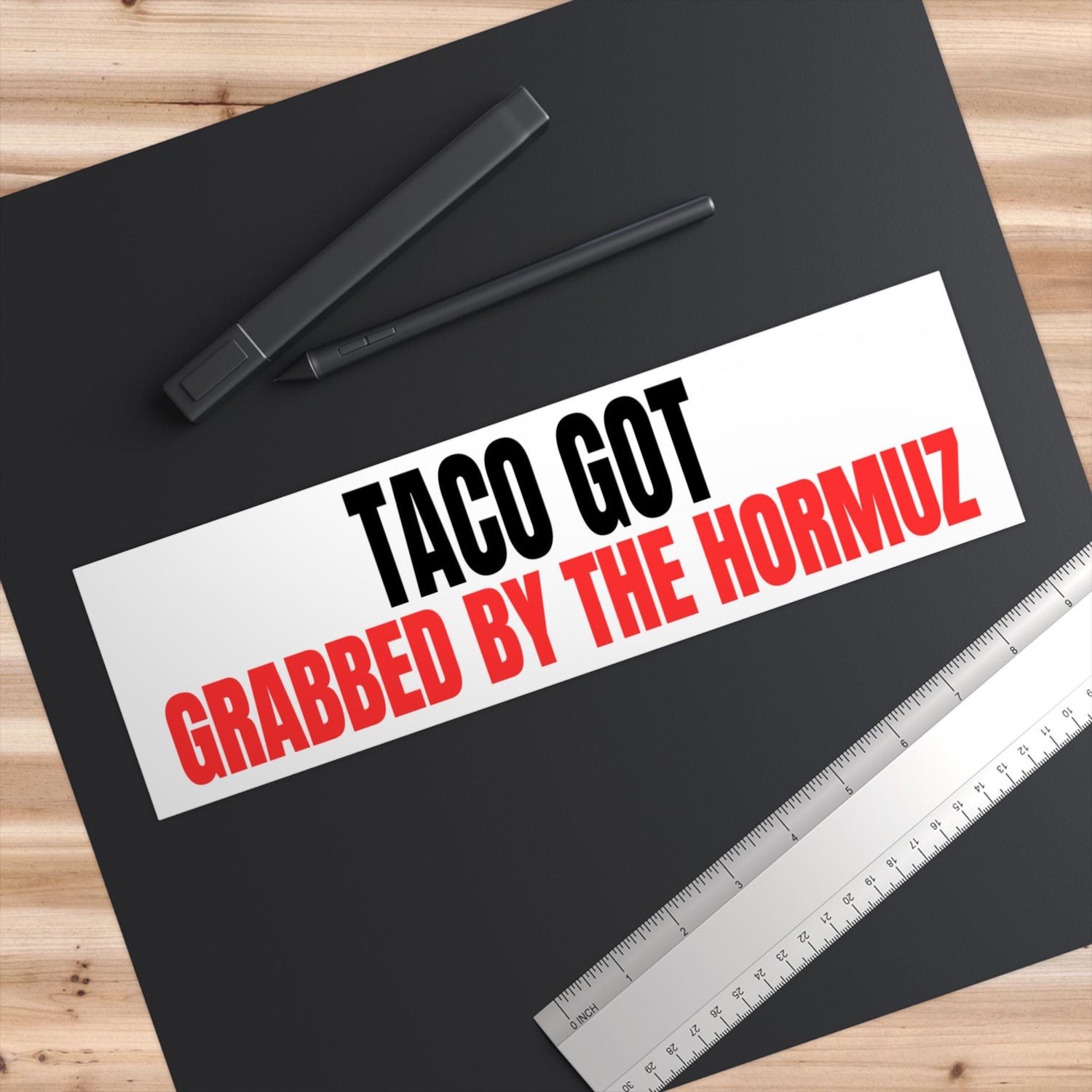 Red and white text sticker reading &amp;quot;TACO GOT GRABBED BY THE HORMUZ&amp;quot;.