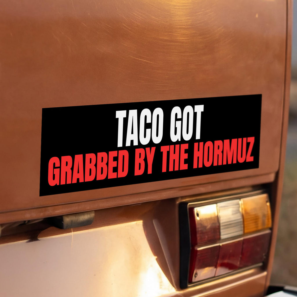 TACO GOT GRABBED BY THE HORMUZ sticker on car bumper.