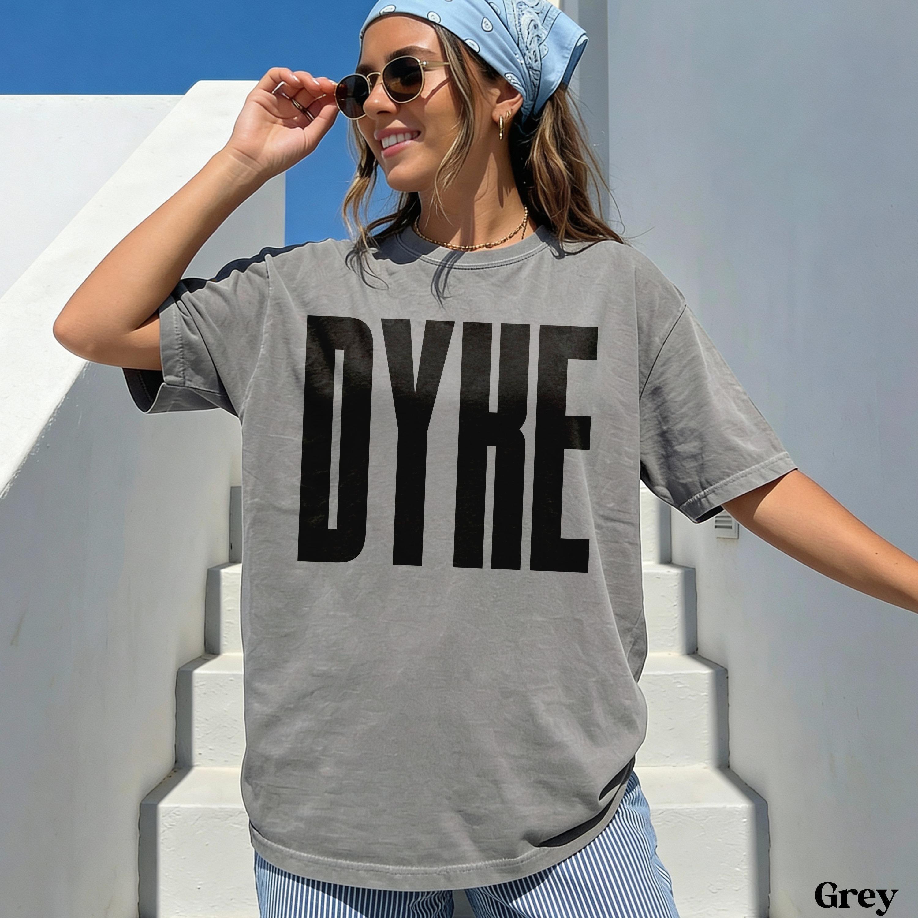 Grey t-shirt with bold black &amp;quot;DYKE&amp;quot; text, worn by a woman.