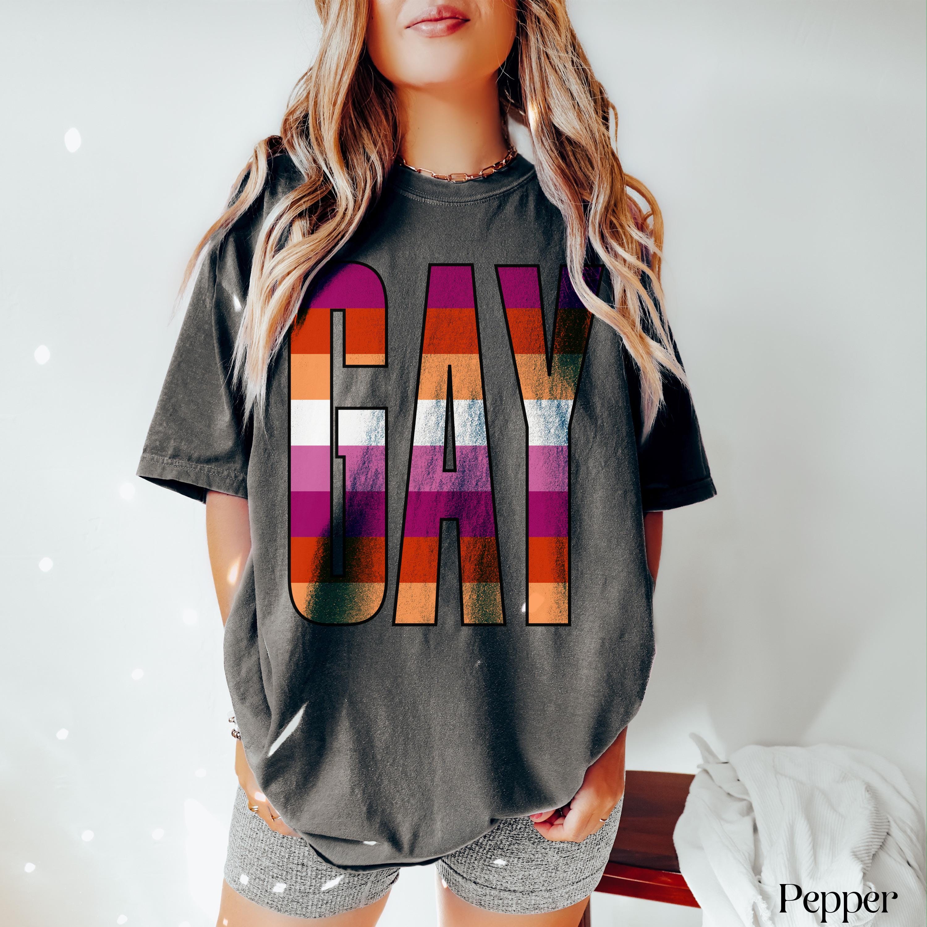 Dark grey t-shirt with &amp;quot;GAY&amp;quot; in rainbow stripes, worn by a person.