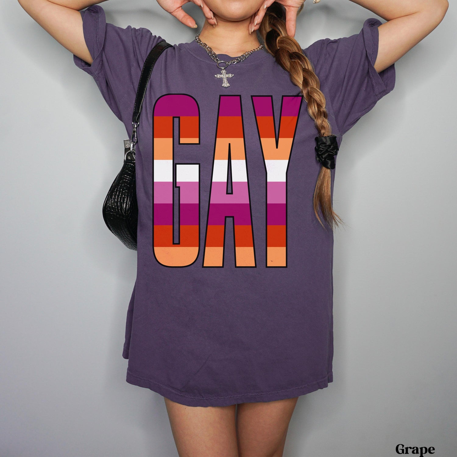 Purple t-shirt with &amp;quot;GAY&amp;quot; in rainbow stripes, worn by a person.