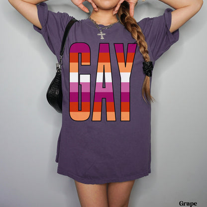 Purple t-shirt with &amp;quot;GAY&amp;quot; in rainbow stripes, worn by a person.