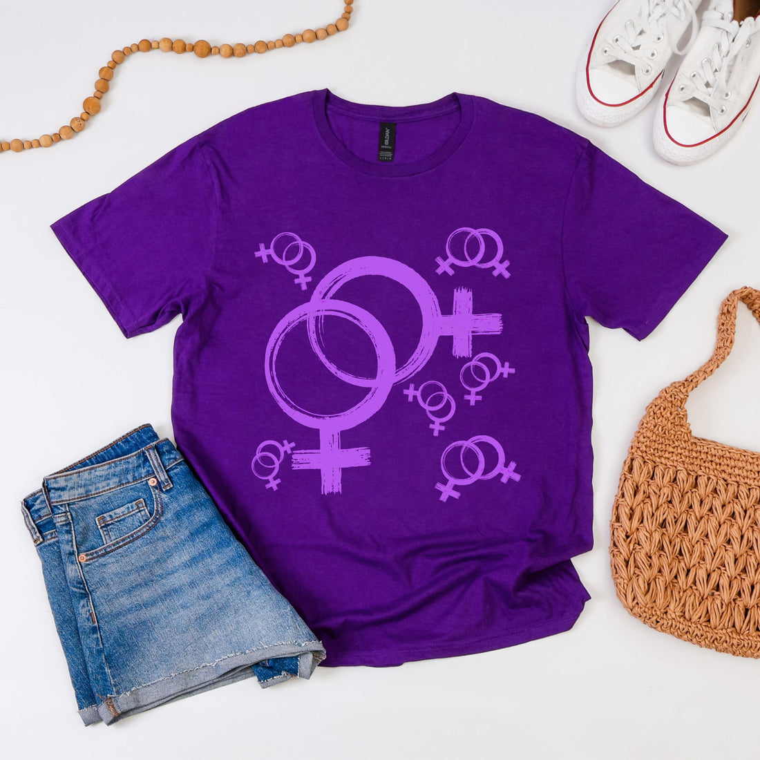 Purple t-shirt with intertwined Venus symbols and smaller Venus symbols.