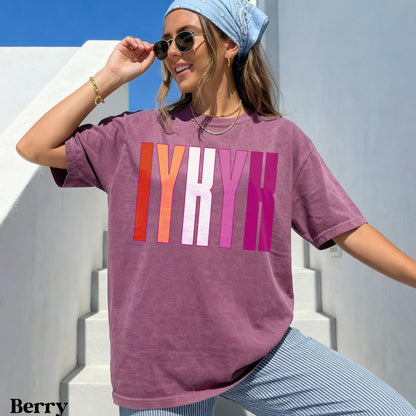 Berry t-shirt with pink and orange &amp;quot;LYRK&amp;quot; graphic on a woman.