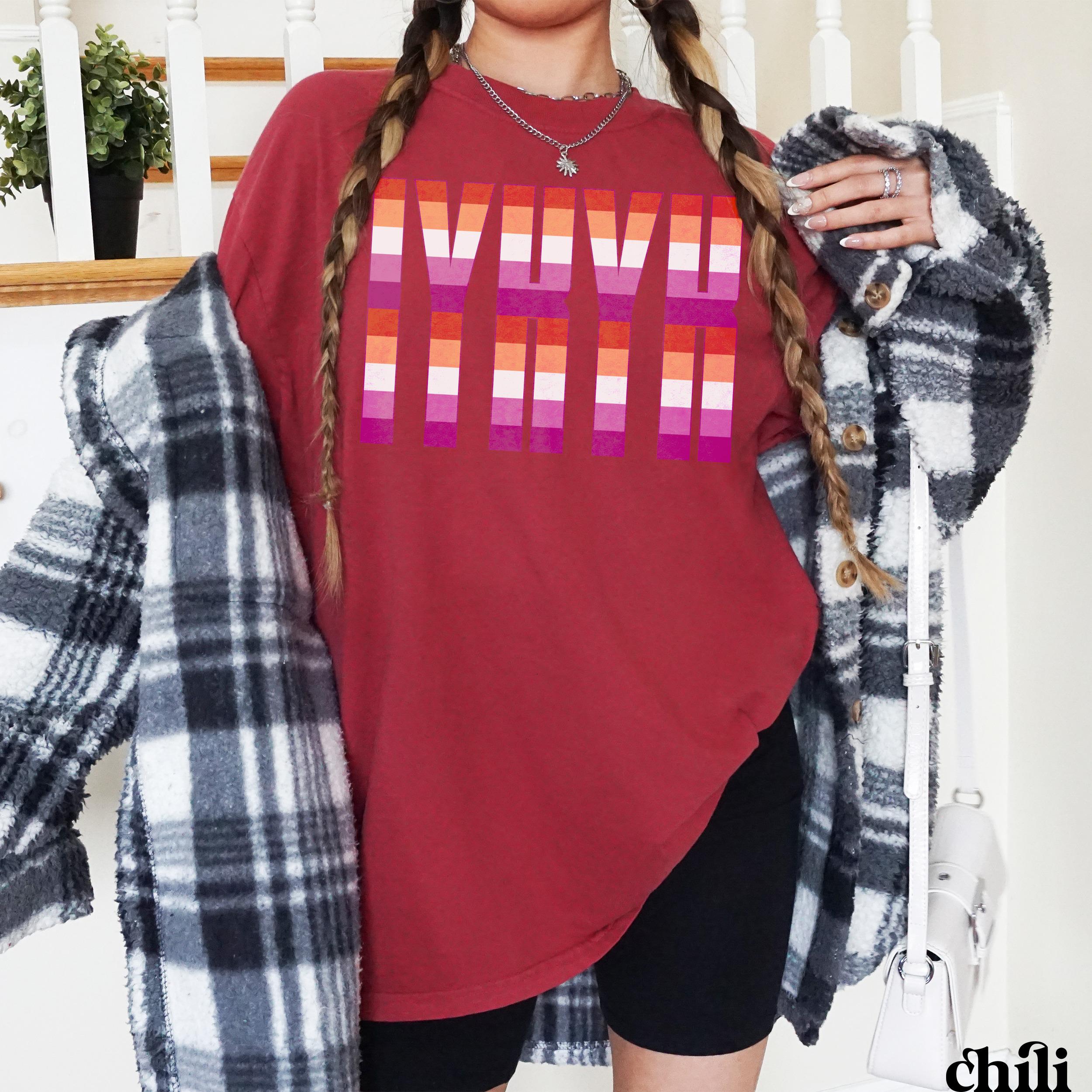 Maroon t-shirt with &amp;quot;LOVE&amp;quot; in rainbow stripes, model wearing plaid shirt.