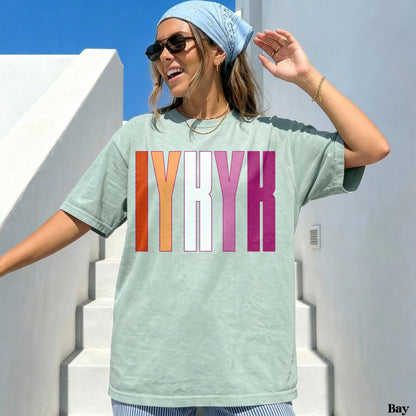 Light green t-shirt with IYRK in LGBTQ+ rainbow stripes.