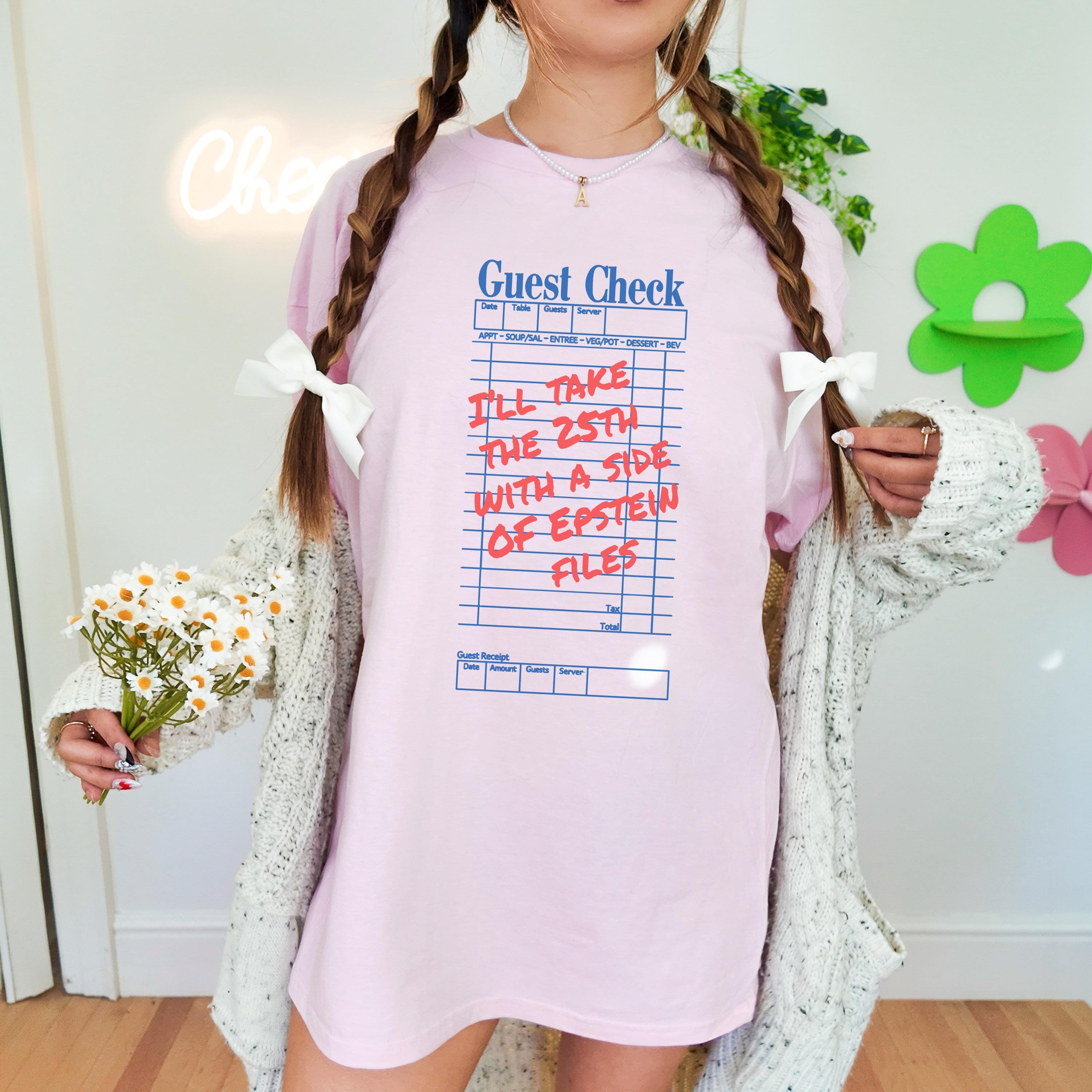 Pink t-shirt with &amp;quot;Guest Check&amp;quot; graphic and text about Epstein files.