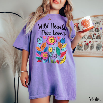 Purple t-shirt with colorful flowers and cats graphic and text &amp;quot;Wild Hearts, Free Love&amp;quot;.