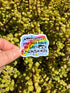 May include: A colorful sticker with the text "Sometimes you just have to say Eww & MOVE ON" over a rainbow design. The sticker is held against a background of green succulent plants.
