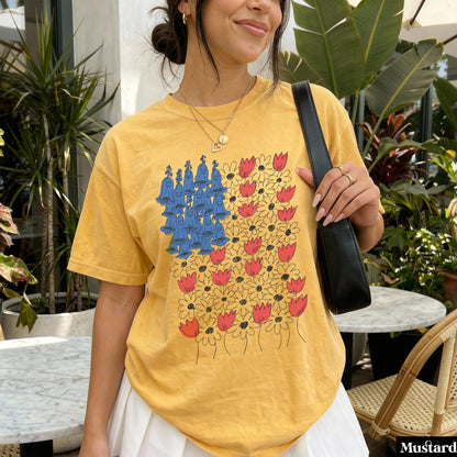 Yellow t-shirt with a floral pattern featuring bluebells and red flowers.
