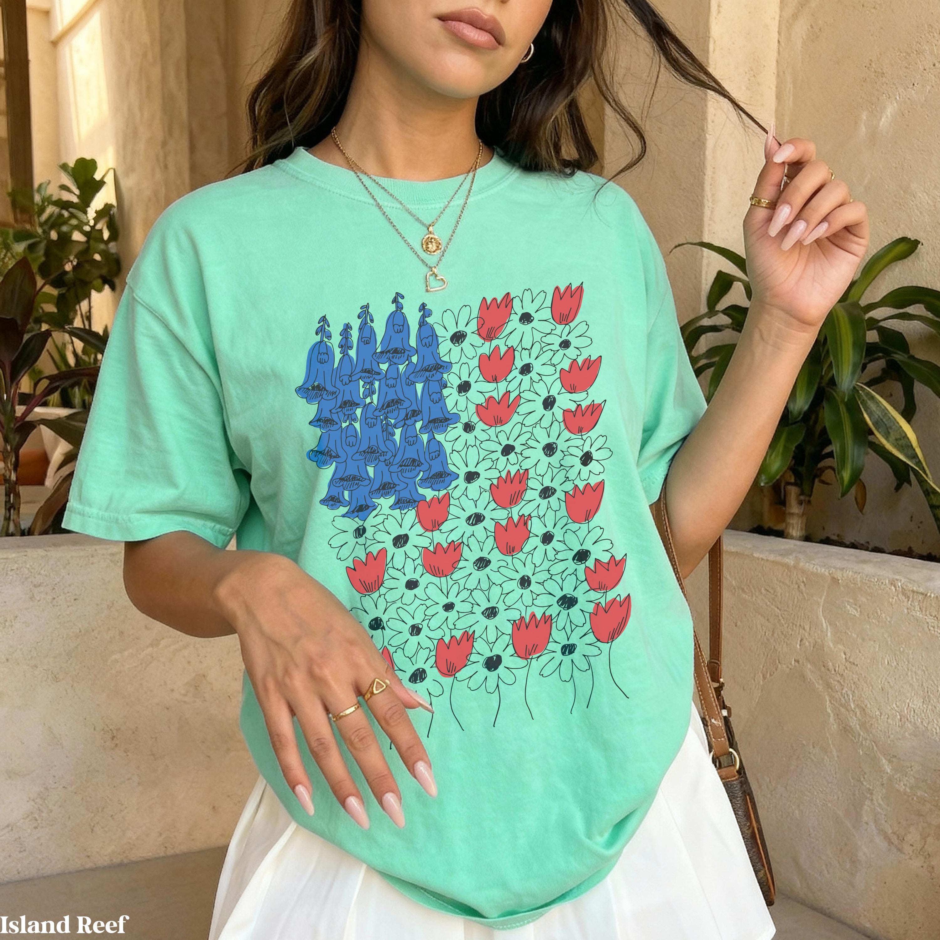 Mint green t-shirt with a floral design of bluebells and tulips.