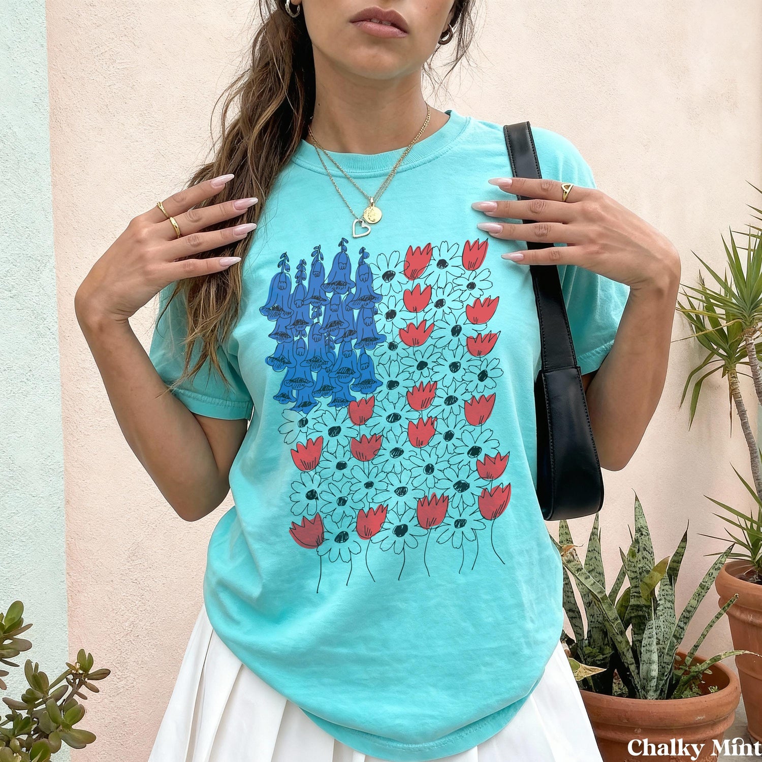 Turquoise t-shirt with a bluebell and red tulip floral print.