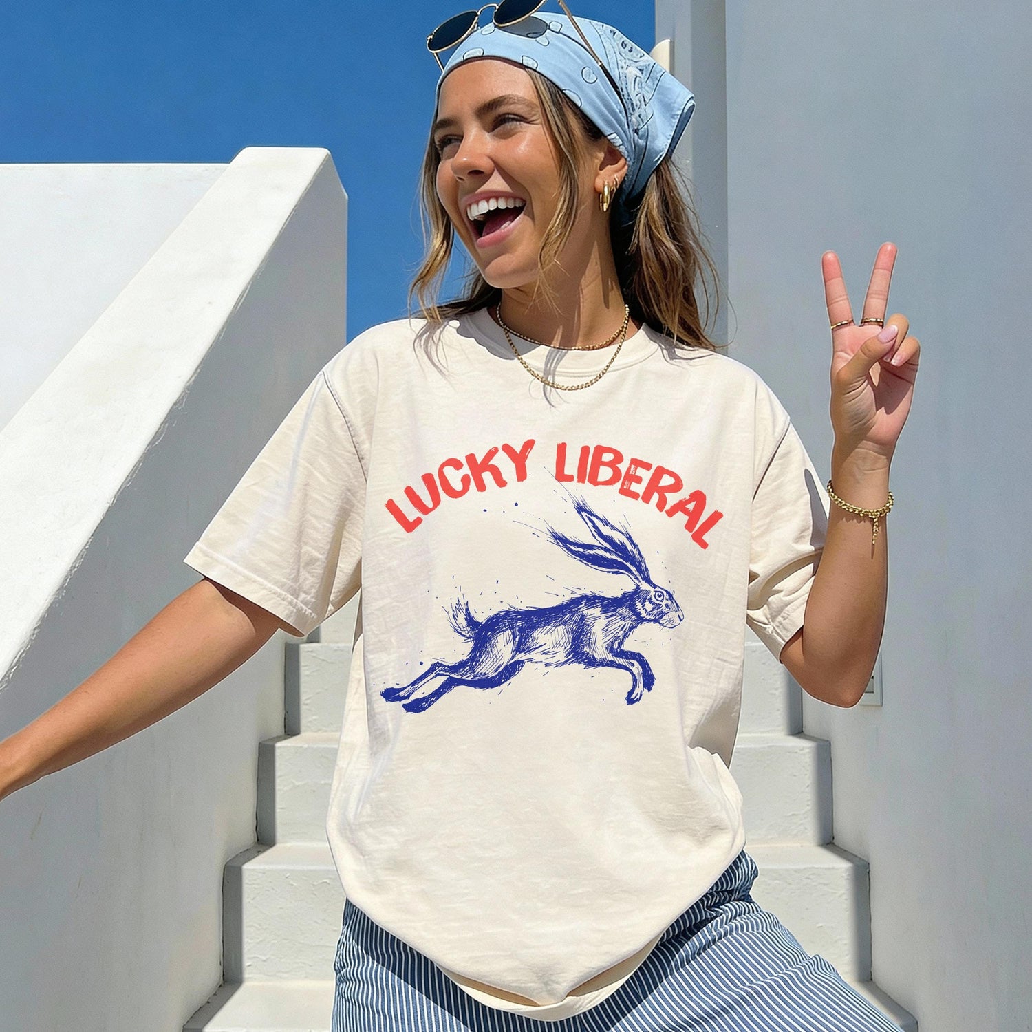 Cream graphic t-shirt with blue &amp;quot;Lucky Liberal&amp;quot; text and a running rabbit.
