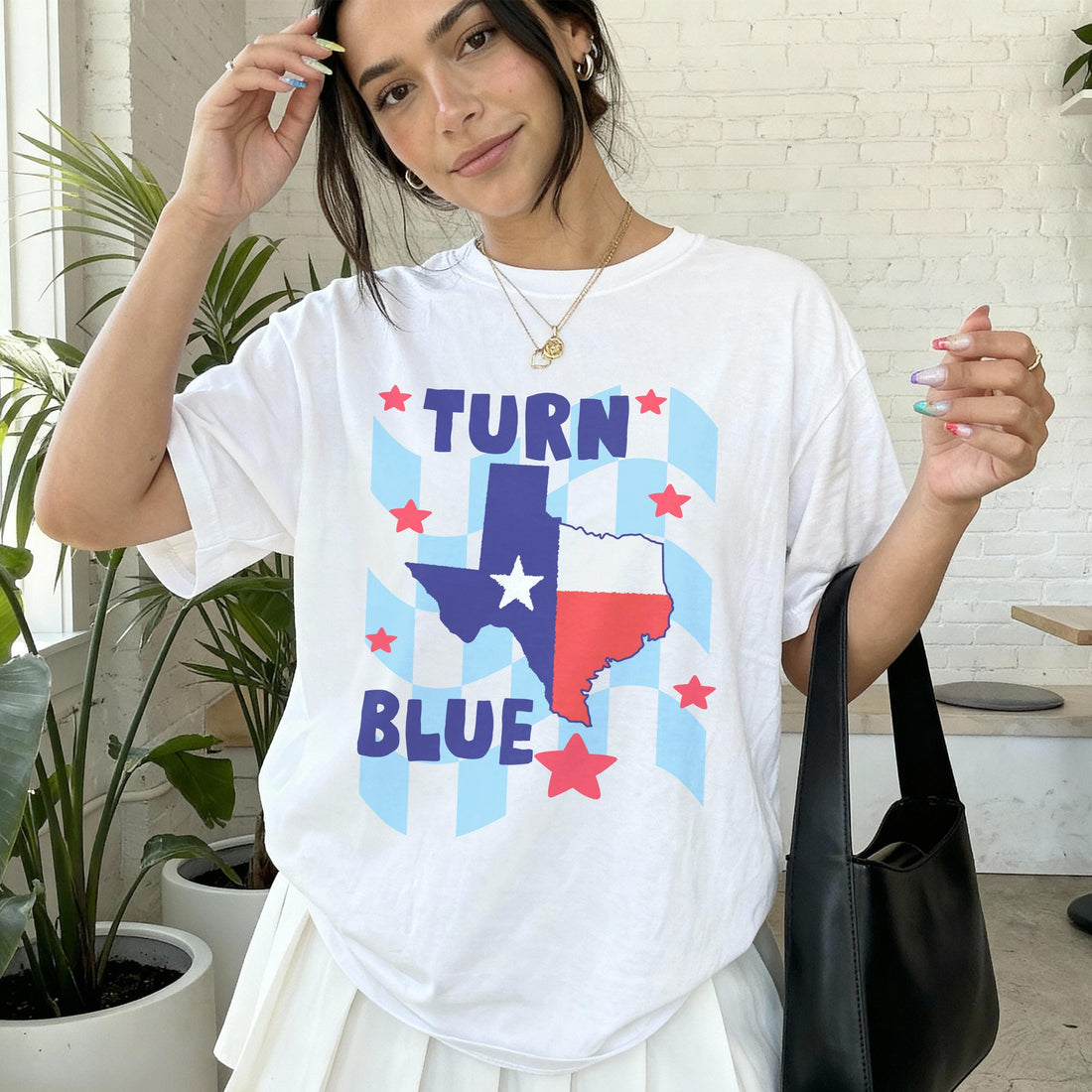 Woman wearing white t-shirt with Texas flag graphic and &amp;quot;TURN BLUE&amp;quot; text.