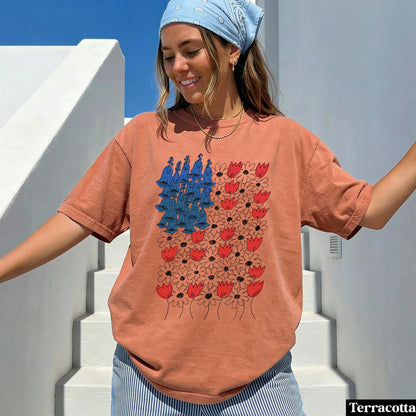 Terracotta t-shirt with blue bellflowers and red tulips graphic.