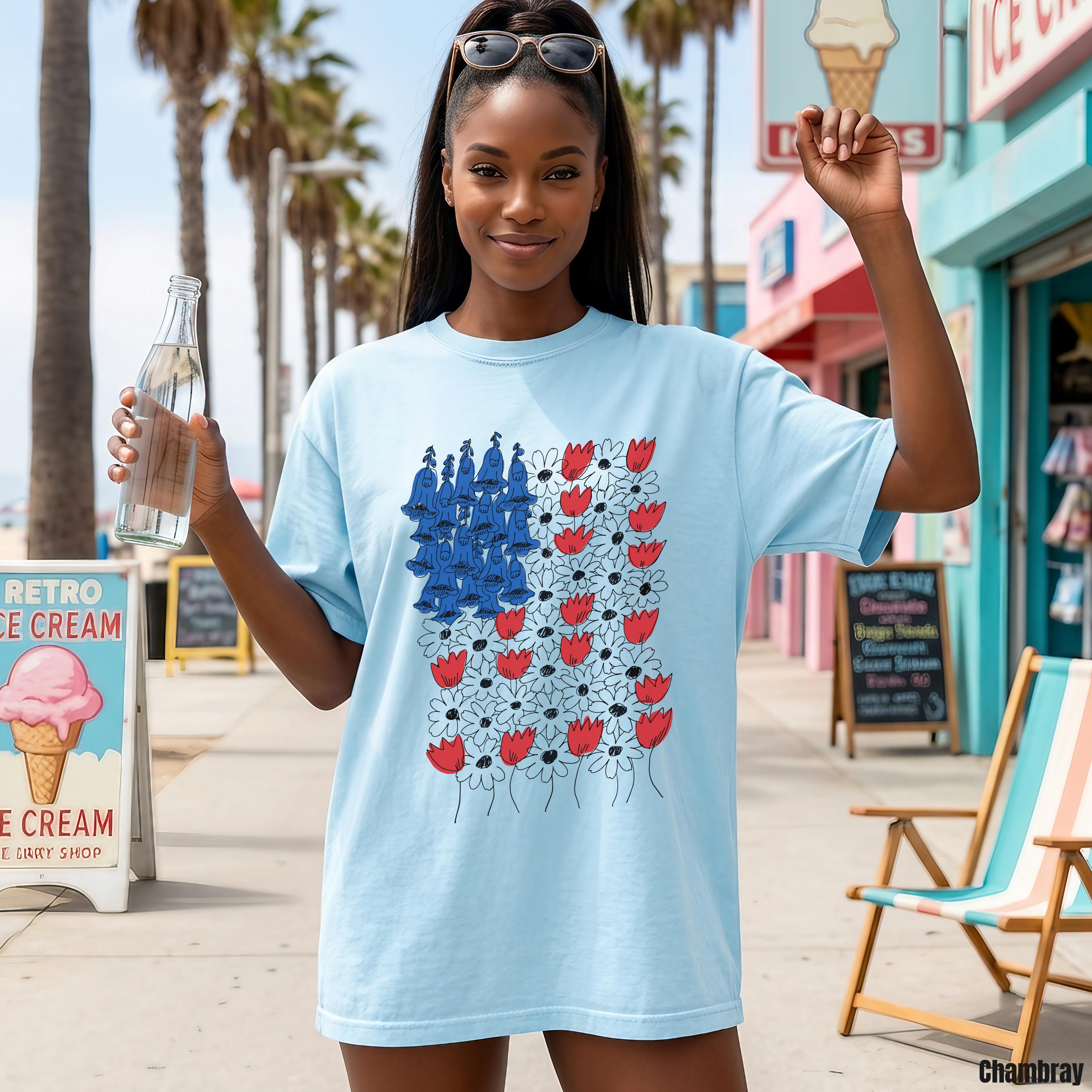 Light blue t-shirt with a graphic of a stylized American flag made of flowers.