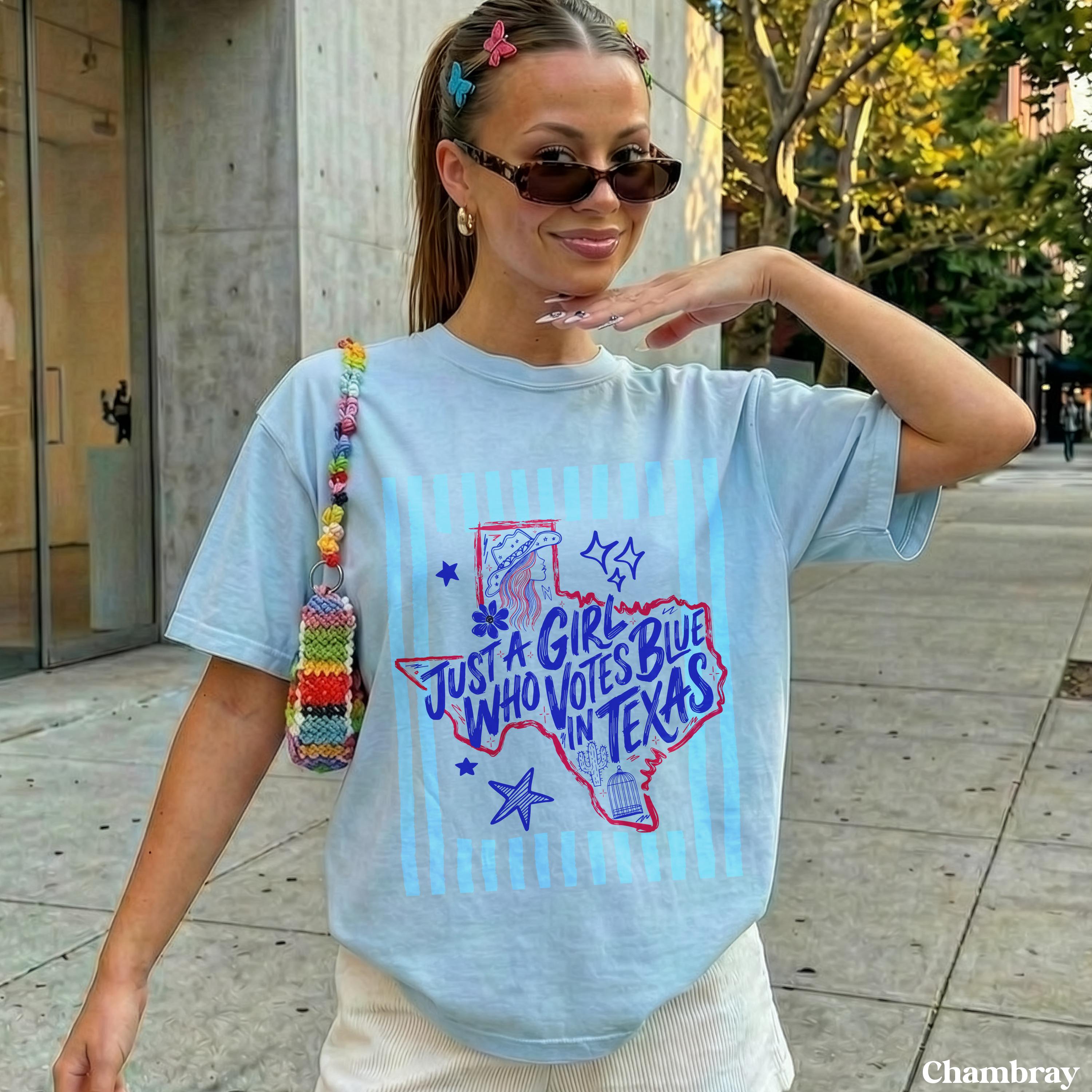 Light blue t-shirt with &amp;quot;Just a girl who votes blue in Texas&amp;quot; text and star graphic.