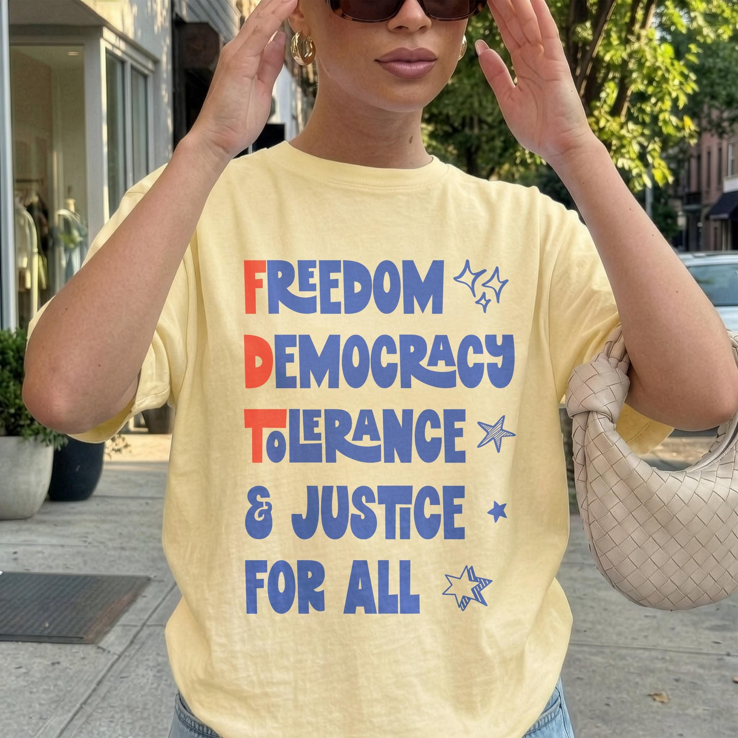 Yellow t-shirt with &amp;quot;Freedom Democracy Tolerance &amp; Justice For All&amp;quot; text in blue and red.