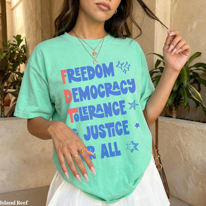 Mint green t-shirt with &amp;quot;Freedom Democracy Tolerance Justice All&amp;quot; text and stars.