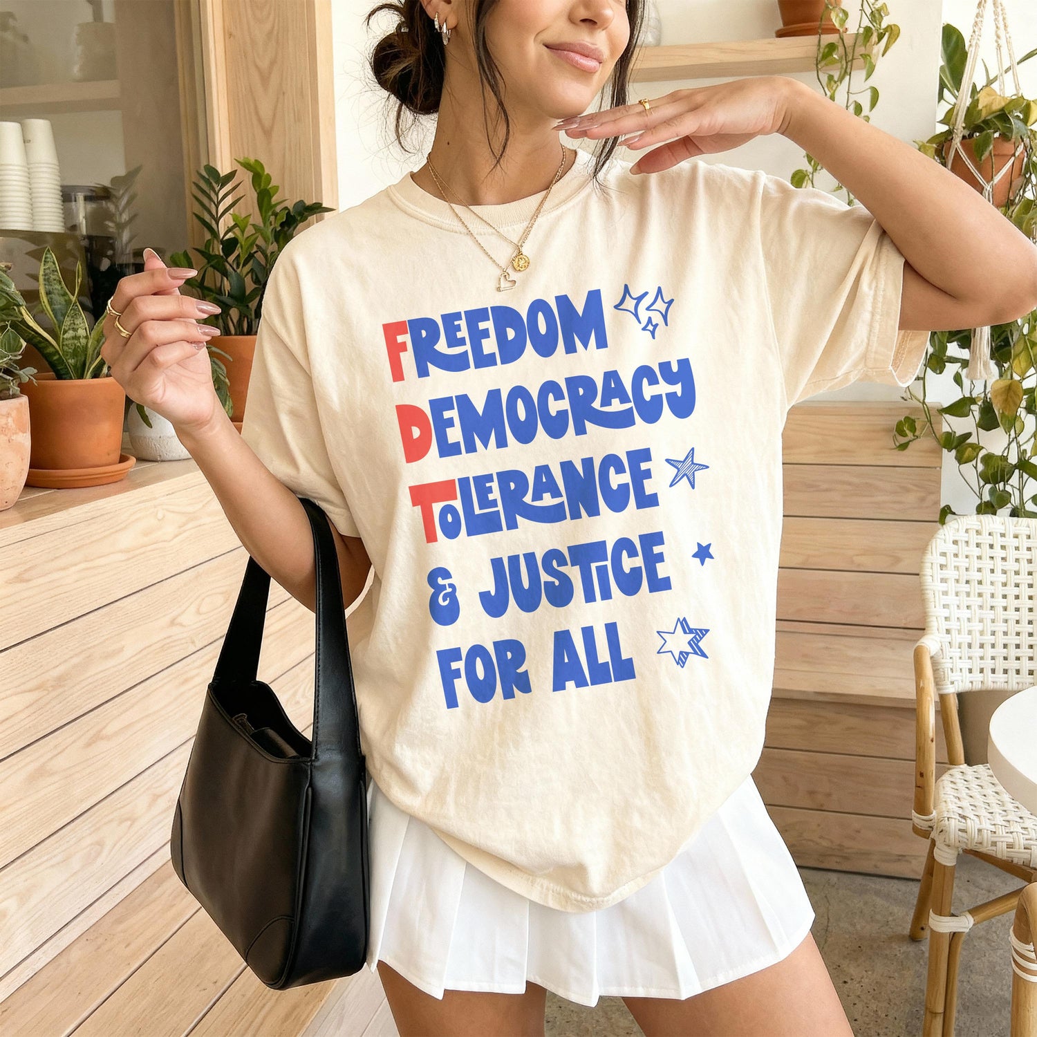 Cream t-shirt with &amp;quot;FREEDOM DEMOCRACY JUSTICE FOR ALL&amp;quot; in blue and red text.