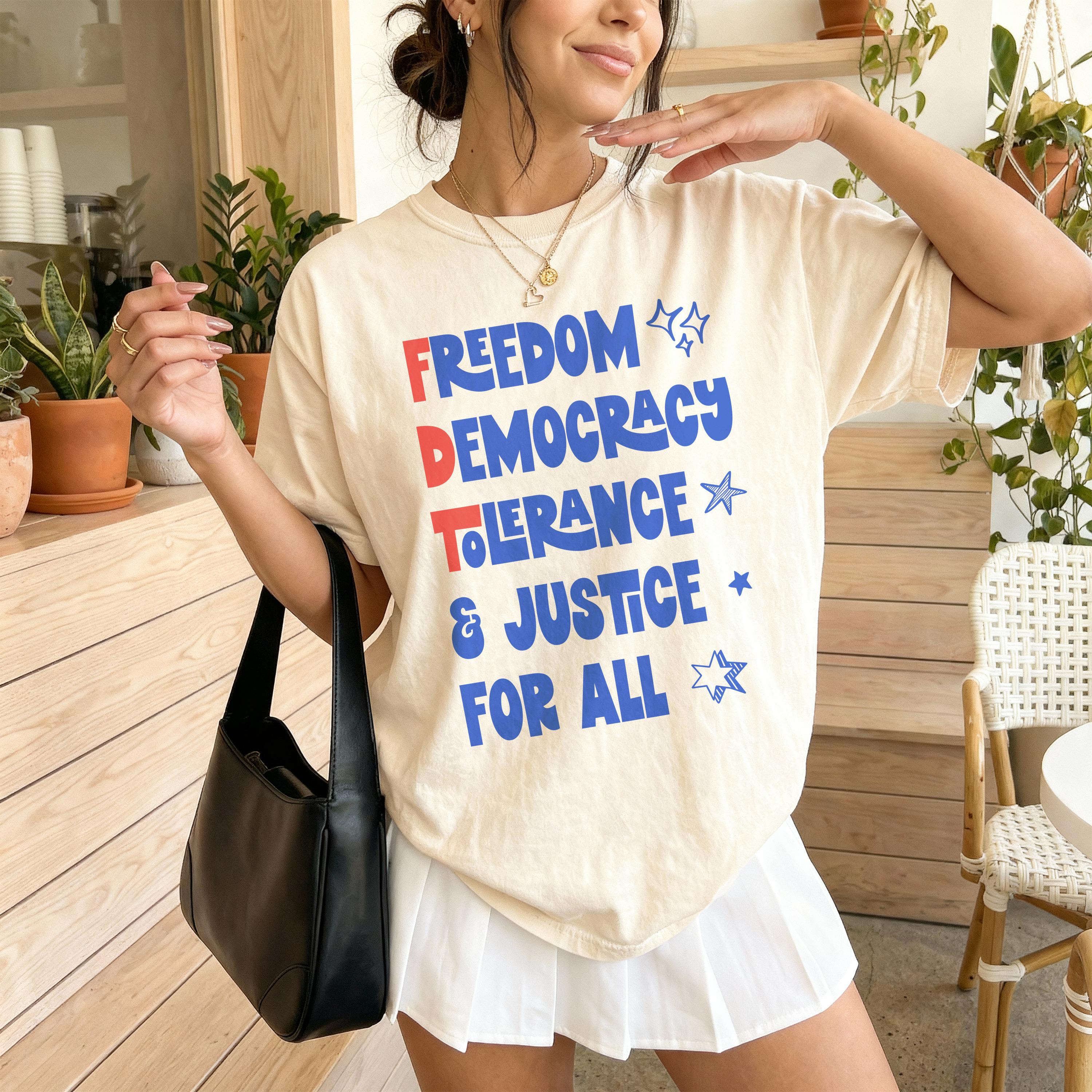 Cream t-shirt with &amp;quot;FREEDOM DEMOCRACY JUSTICE FOR ALL&amp;quot; in blue and red text.