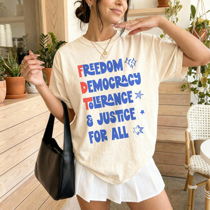 Cream t-shirt with &amp;quot;FREEDOM DEMOCRACY JUSTICE FOR ALL&amp;quot; in blue and red text.