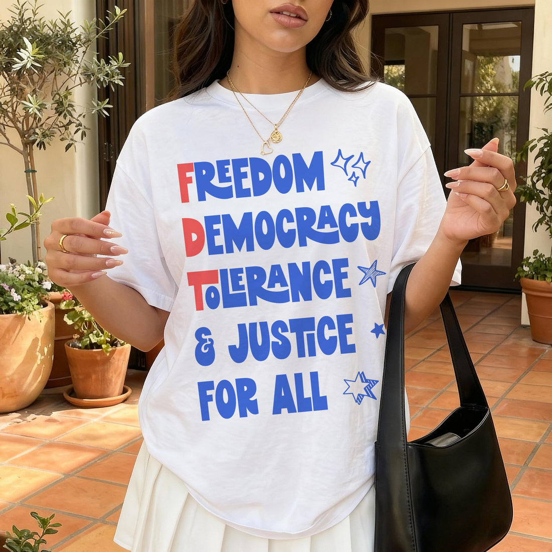 White t-shirt with &amp;quot;Freedom Democracy Tolerance Justice for All&amp;quot; text and stars.